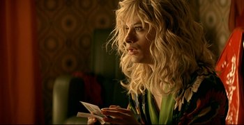 Movie still from “Bad Education” (2004), directed by Pedro Almodóvar – A woman with long blonde hair is holding a piece of paper; Close Up shot, Over the shoulder angle