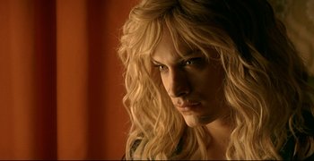 Movie still from “Bad Education” (2004), directed by Pedro Almodóvar – A person with long blonde hair; Close Up shot, Over the shoulder angle