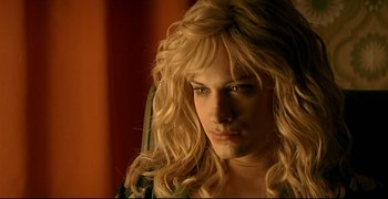 Movie still from “Bad Education” (2004), directed by Pedro Almodóvar – A woman with long blonde hair stares into the camera; Close Up shot, Over the shoulder angle