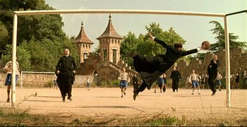 Movie still from “Bad Education” (2004), directed by Pedro Almodóvar – A group of men playing a game of soccer; Wide shot, High angle
