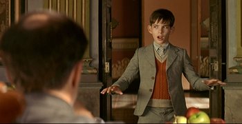 Movie still from “Bad Education” (2004), directed by Pedro Almodóvar – A young boy is standing in front of a mirror; Medium shot, Over the shoulder angle