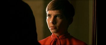 Movie still from “Bad Education” (2004), directed by Pedro Almodóvar – A woman in a red dress is looking at the camera; Close Up shot, Over the shoulder angle