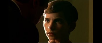 Movie still from “Bad Education” (2004), directed by Pedro Almodóvar – A woman with a needle in her hair looking at the camera; Close Up shot, Over the shoulder angle