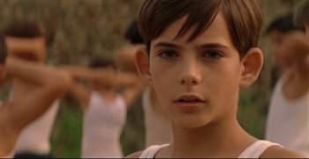 Movie still from “Bad Education” (2004), directed by Pedro Almodóvar – A young boy is looking into the distance; Close Up shot, Over the shoulder angle