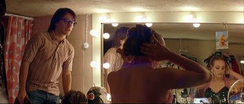 Movie still from “Bad Education” (2004), directed by Pedro Almodóvar – A woman getting her hair done in front of a mirror; Medium shot, Over the shoulder angle