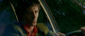 Movie still from “Bad Education” (2004), directed by Pedro Almodóvar – A person sitting in a car; Close Up shot, Over the shoulder angle