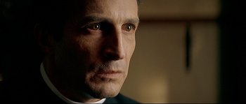 Movie still from “Bad Education” (2004), directed by Pedro Almodóvar – A man's face in a dark room; Close Up shot, Over the shoulder angle