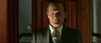 Movie still from “Bad Education” (2004), directed by Pedro Almodóvar – A person wearing a suit and tie; Close Up shot, Low angle