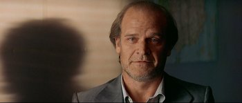 Movie still from “Bad Education” (2004), directed by Pedro Almodóvar – A person wearing a suit and tie; Close Up shot, Low angle