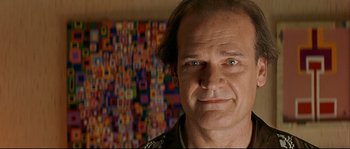 Movie still from “Bad Education” (2004), directed by Pedro Almodóvar – A person wearing a black shirt; Close Up shot, Over the shoulder angle