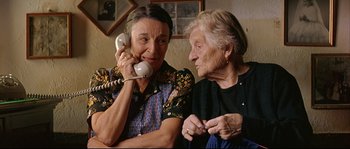Movie still from “Bad Education” (2004), directed by Pedro Almodóvar – Two older women sitting next to each other; Close Up shot, High angle