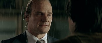 Movie still from “Bad Education” (2004), directed by Pedro Almodóvar – A person wearing a suit and tie; Close Up shot, Over the shoulder angle