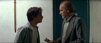 Movie still from “Bad Education” (2004), directed by Pedro Almodóvar – A man and a boy talking to each other; Medium shot, Over the shoulder angle