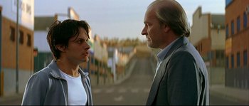 Movie still from “Bad Education” (2004), directed by Pedro Almodóvar – A man and a woman standing next to each other on the street; Close Up shot, Low angle