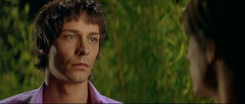Movie still from “Bad Education” (2004), directed by Pedro Almodóvar – A person wearing a purple shirt; Close Up shot, Over the shoulder angle