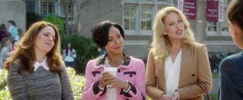 Movie still from “Bad Moms” (2016), directed by Scott Moore – A woman in a pink jacket holding a cup of coffee; Medium shot, Over the shoulder angle