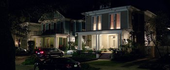 Movie still from “Bad Moms” (2016), directed by Scott Moore – A row of houses at night with a car parked in front of them; Extreme Wide shot, High angle