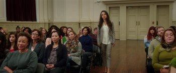 Movie still from “Bad Moms” (2016), directed by Scott Moore – A group of people sitting and standing in a room; Wide shot, Over the shoulder angle