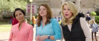 Movie still from “Bad Moms” (2016), directed by Scott Moore – A group of women standing next to each other on a sidewalk; Medium shot, Over the shoulder angle