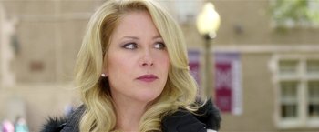 Movie still from “Bad Moms” (2016), directed by Scott Moore – A person with long blonde hair; Close Up shot, Over the shoulder angle