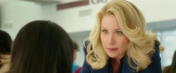 Movie still from “Bad Moms” (2016), directed by Scott Moore – A woman with blonde curly hair sitting in front of another woman; Close Up shot, Over the shoulder angle