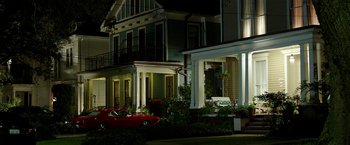 Movie still from “Bad Moms” (2016), directed by Scott Moore – A red car parked in front of a house at night; Extreme Wide shot, Low angle