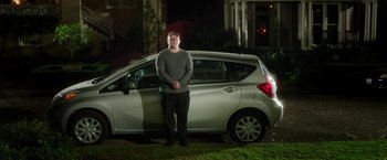 Movie still from “Bad Moms” (2016), directed by Scott Moore – A man standing in front of a car at night; Wide shot, Low angle