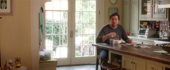 Movie still from “Bad Moms” (2016), directed by Scott Moore – A man sitting at a table with a bowl of cereal; Medium shot, Over the shoulder angle