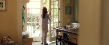 Movie still from “Bad Moms” (2016), directed by Scott Moore – A woman standing in front of an open door; Wide shot, Over the shoulder angle