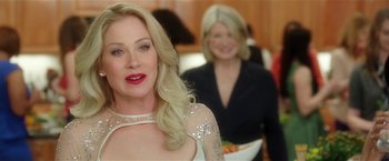 Movie still from “Bad Moms” (2016), directed by Scott Moore – A woman with blonde hair wearing a white dress; Close Up shot, Over the shoulder angle