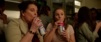 Movie still from “Bad Moms” (2016), directed by Scott Moore – Two women are sitting and drinking from cans; Medium shot, High angle