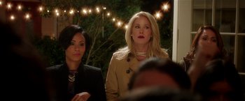 Movie still from “Bad Moms” (2016), directed by Scott Moore – Two women standing next to each other in front of lights; Close Up shot, Over the shoulder angle