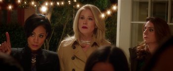 Movie still from “Bad Moms” (2016), directed by Scott Moore – A woman with blonde hair wearing a trench coat; Close Up shot, Over the shoulder angle