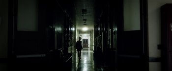 Movie still from “Bad Moms” (2016), directed by Scott Moore – A person walking down a hallway in the dark; Extreme Wide shot, Low angle