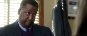 Movie still from “Bad Moms” (2016), directed by Scott Moore – A person wearing a suit and tie; Close Up shot, Over the shoulder angle