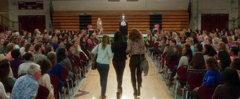 Movie still from “Bad Moms” (2016), directed by Scott Moore – Three women walking in front of a crowd of people in front of an audience; Extreme Wide shot, High angle