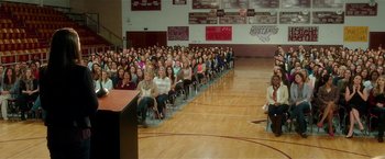 Movie still from “Bad Moms” (2016), directed by Scott Moore – A large group of people sitting in a gymnasium; Extreme Wide shot, High angle