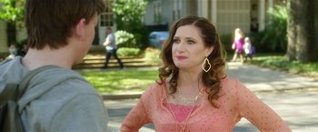 Movie still from “Bad Moms” (2016), directed by Scott Moore – A woman in a pink blouse talking to a man; Medium shot, Over the shoulder angle