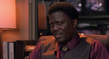 Movie still from “Bad Santa” (2003), directed by Terry Zwigoff – A person wearing a suit and tie; Close Up shot, High angle