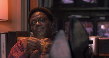 Movie still from “Bad Santa” (2003), directed by Terry Zwigoff – A person holding a piece of food; Close Up shot, High angle