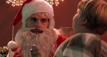 Movie still from “Bad Santa” (2003), directed by Terry Zwigoff – A man dressed as santa claus talking to a boy; Close Up shot, Over the shoulder angle