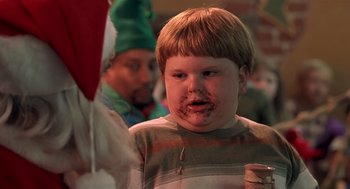 Movie still from “Bad Santa” (2003), directed by Terry Zwigoff – A young boy with chocolate on his face; Close Up shot, Over the shoulder angle