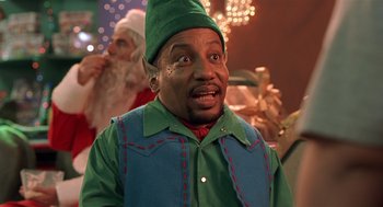 Movie still from “Bad Santa” (2003), directed by Terry Zwigoff – A man dressed up as an elf with a surprised look on his face; Close Up shot, Low angle