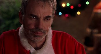 Movie still from “Bad Santa” (2003), directed by Terry Zwigoff – A person wearing a santa suit; Close Up shot, Over the shoulder angle