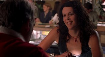 Movie still from “Bad Santa” (2003), directed by Terry Zwigoff – A woman sitting in front of another woman at a table; Close Up shot, Over the shoulder angle