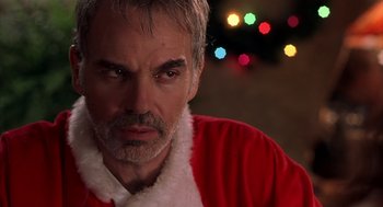 Movie still from “Bad Santa” (2003), directed by Terry Zwigoff – A person wearing a santa suit; Close Up shot, Over the shoulder angle