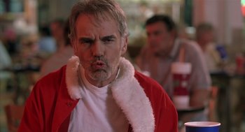 Movie still from “Bad Santa” (2003), directed by Terry Zwigoff – A person wearing a santa clause costume; Close Up shot, Low angle
