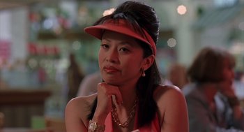 Movie still from “Bad Santa” (2003), directed by Terry Zwigoff – A woman wearing a red hat and a gold necklace; Close Up shot, Low angle