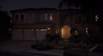 Movie still from “Bad Santa” (2003), directed by Terry Zwigoff – A night time picture of a house in the dark; Extreme Wide shot, High angle