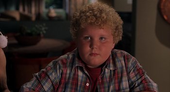 Movie still from “Bad Santa” (2003), directed by Terry Zwigoff – A person with curly blond hair; Close Up shot, High angle